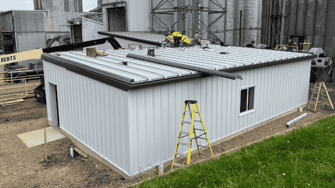 Simonson Construction employees installing metal roofing on an addition at Centerra Co-op in Mansfield, Ohio.