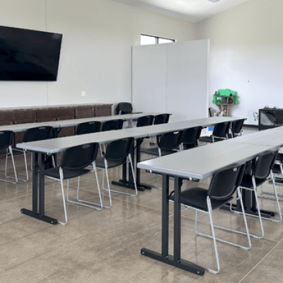 Interior of the Davy McClure Outdoor Education Center classroom featuring vaulted ceilings, natural light from tall windows, and flexible seating.
