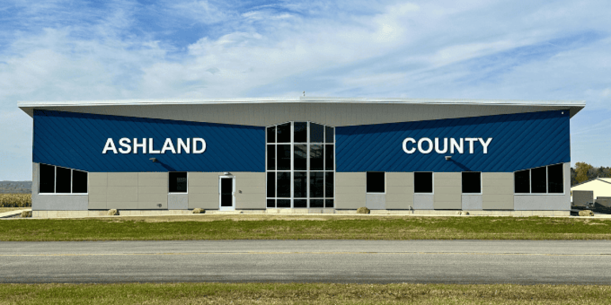 The East entrance of the new airport terminal building features large white lettering that spells out "Ashland County."