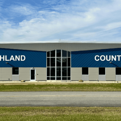 The East entrance of the new airport terminal building features large white lettering that spells out "Ashland County."