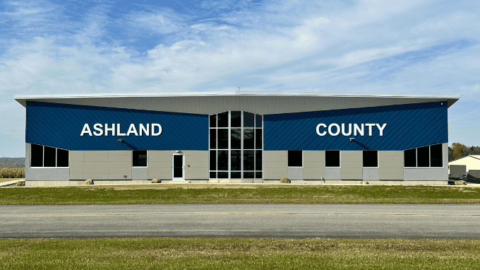 The East entrance of the new airport terminal building features large white lettering that spells out "Ashland County."