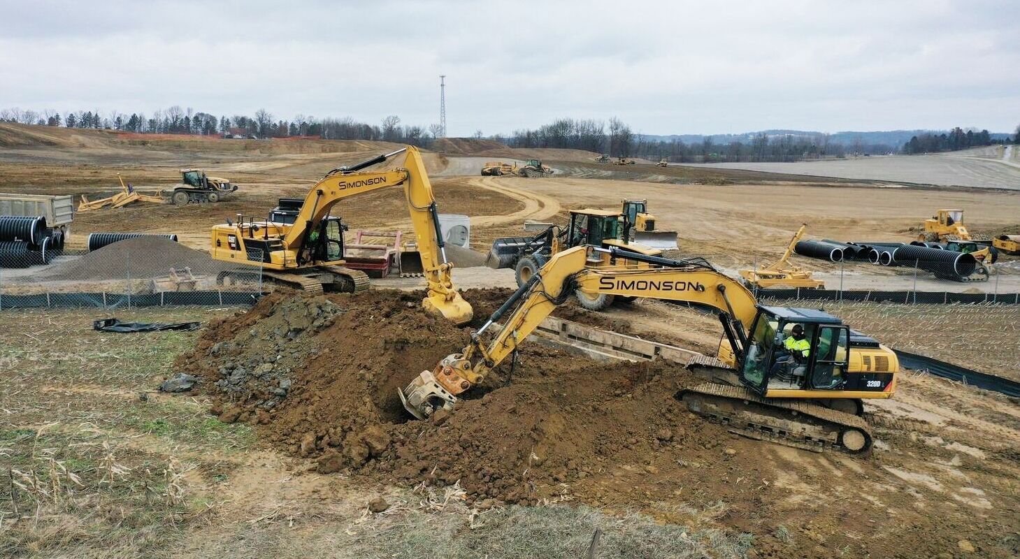 excavation equipment moving dirt during early sitework phase