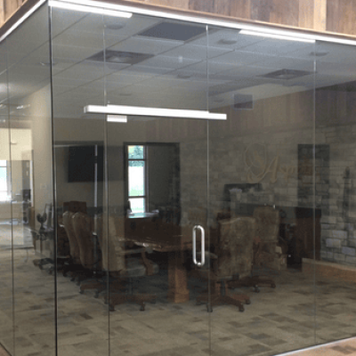 Glass walls surround the conference room table and chairs at the Aspen Management office.