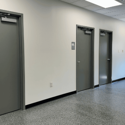 A hallway in Harris Welding's new metal building addition features two unisex restrooms.