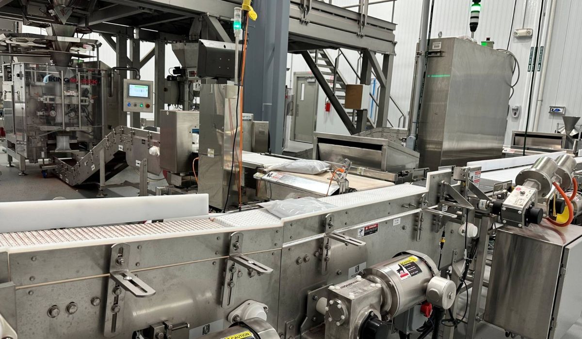 conveyor belt with bagged product being transported to packaging room