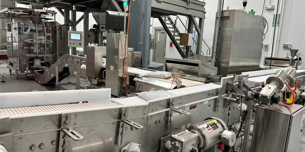 conveyor belt with bagged product being transported to packaging room