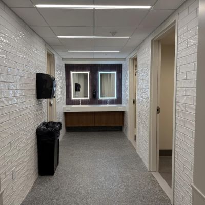 A vanity mirror is above each sink at the double sink in restroom pods at Ashland University Amstutz Hall.