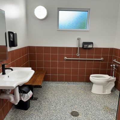 ADA-compliant restroom with toilet and sink, part of the new bathhouse at Jellystone Park designed and built by Simonson Construction.