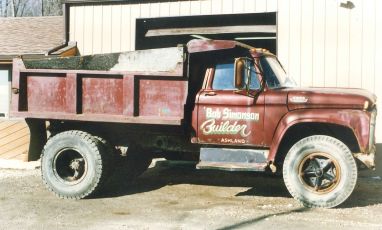 A maroon 1966 Ford F800 dump truck was the first dump truck purchased by Bob Simonson for Bob Simonson Builder