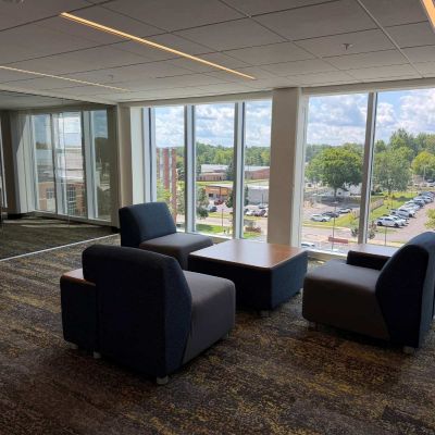 Three plush chairs and an ottoman can be found in the study lounge at Ashland University Amstutz Hall.